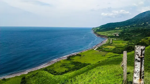 Green rolling hills of Vayang above the sea, North Batan