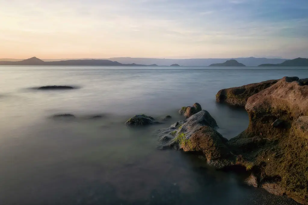 Taal Volcano Island and Taal Lake at sunset, seen from the Batangas shore