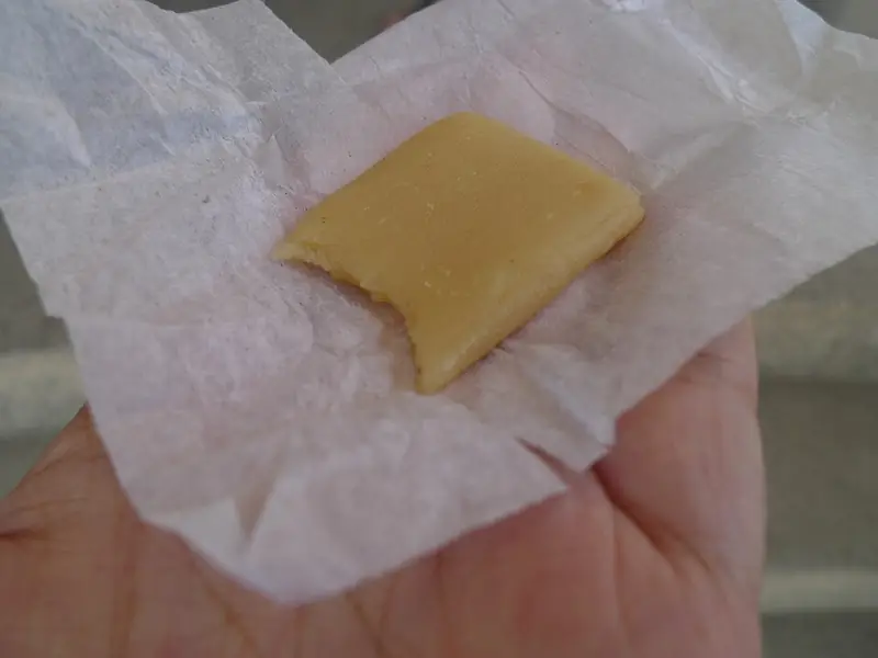 An unwrapped piece of pastillas de leche milk candy (photographed in Cagayan)