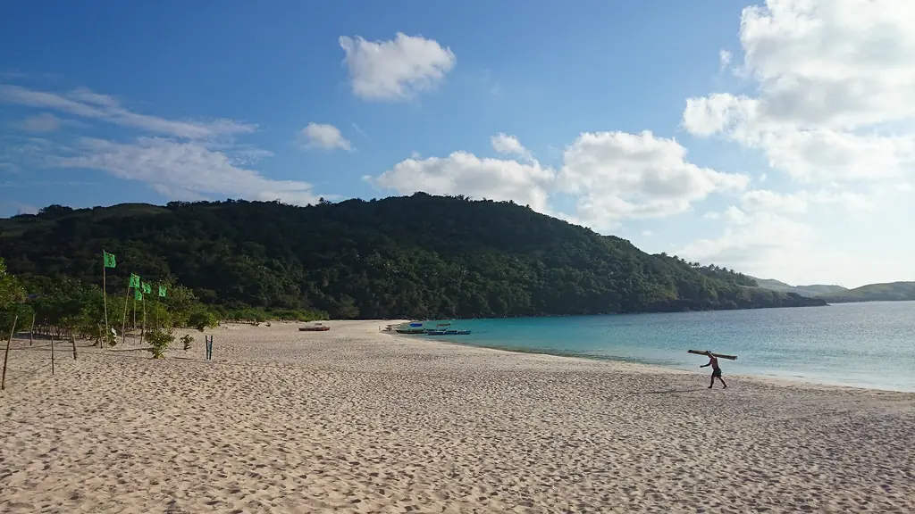 A long white-sand beach and green hills on the Calaguas Islands