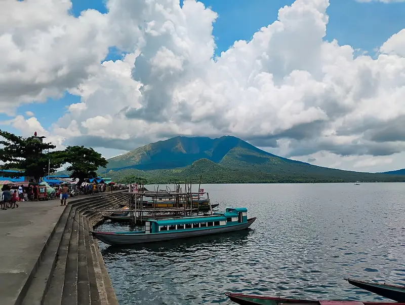Boats moored on Lake Buhi below Mount Asog