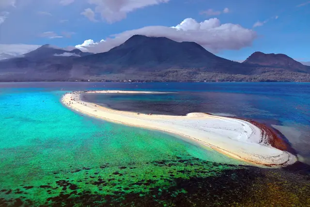 White Island sandbar in turquoise water with Camiguin's volcanoes behind