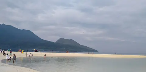 The curving white sandbar of White Island with Camiguin's mountains behind