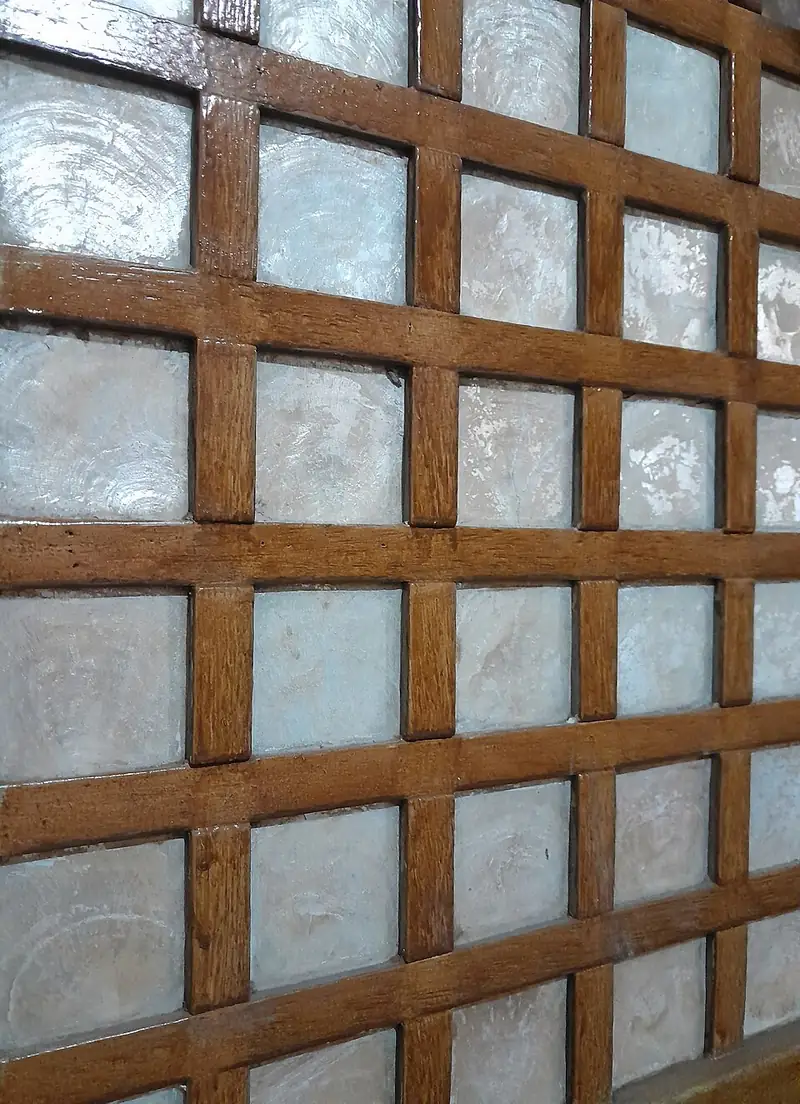 Close-up of a window with translucent capiz-shell panes in a wooden grid