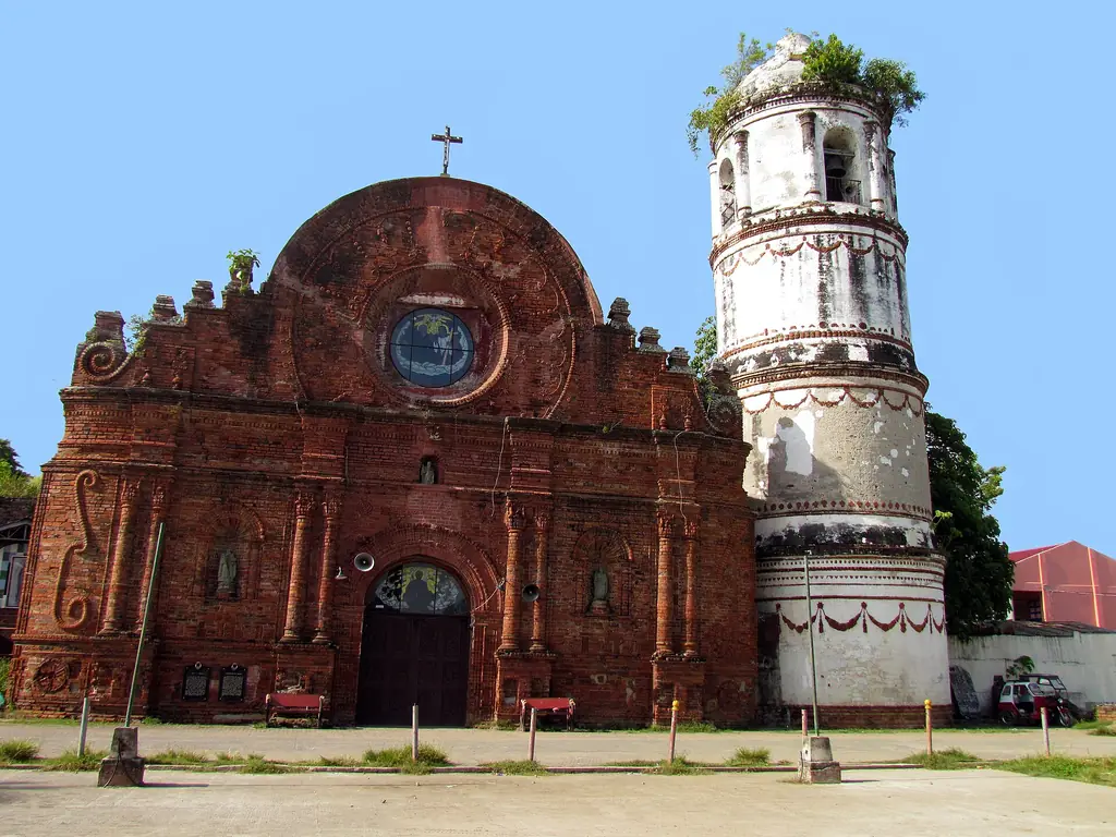 The red-brick Church of Tumauini (St. Matthias) and its round bell tower