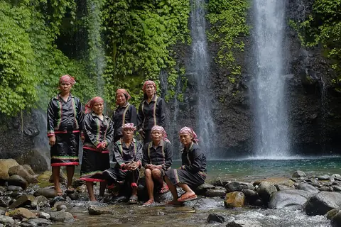 Subanen men and women of Mount Malindang at a waterfall
