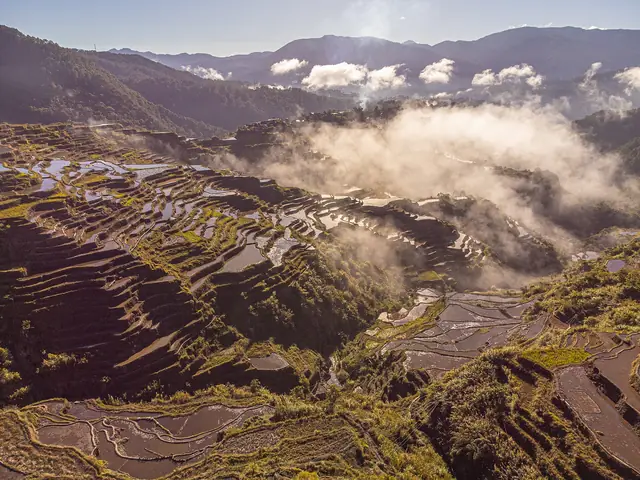 Stone-walled Maligcong rice terraces and mountains from above, near Bontoc