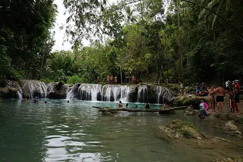 Visitors and rafts on the lower pool of Cambugahay Falls