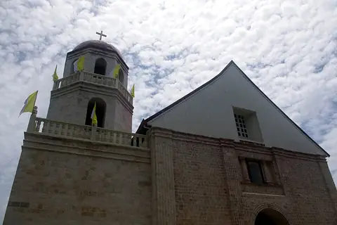 The coral-stone facade and bell tower of Lazi Church