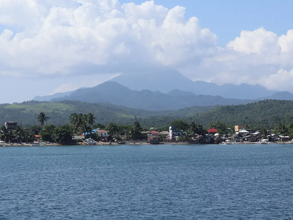 Mount Bulusan rising behind the coast at Matnog, seen from the San Bernardino Strait