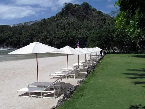 Beach umbrellas and lawn at Dakak Beach Resort